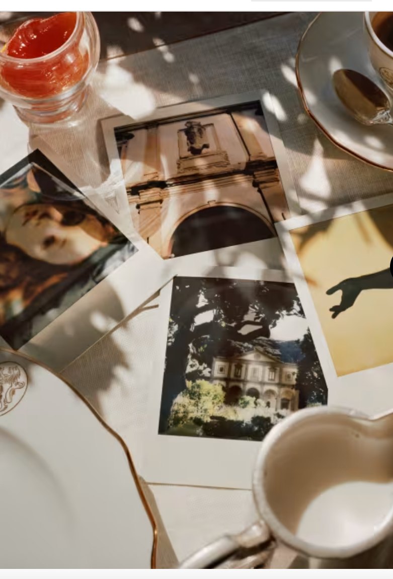 Sunlit photographs and coffee on a linen table